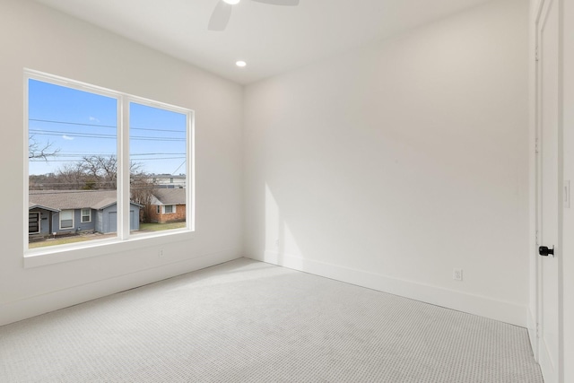 unfurnished room with ceiling fan and light colored carpet