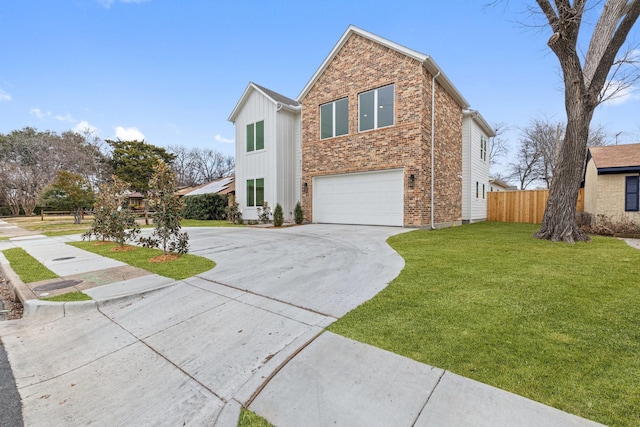 view of front of house featuring a front yard and a garage