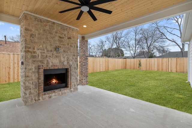 view of patio featuring ceiling fan and a fireplace