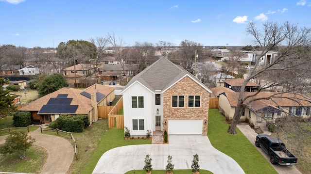 view of front of home featuring a front lawn, a garage, and solar panels