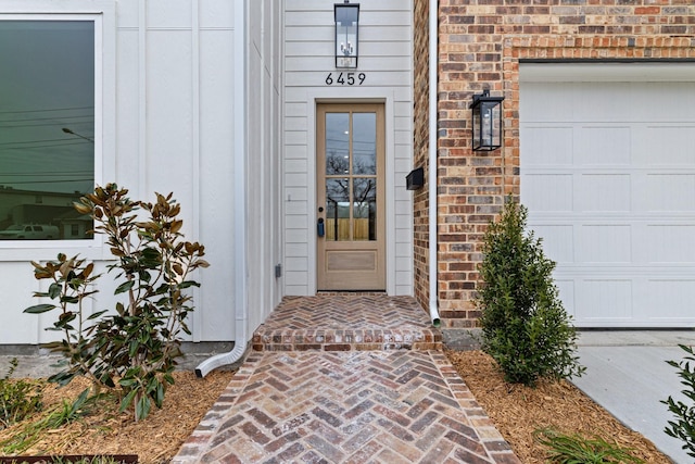 view of exterior entry featuring a garage