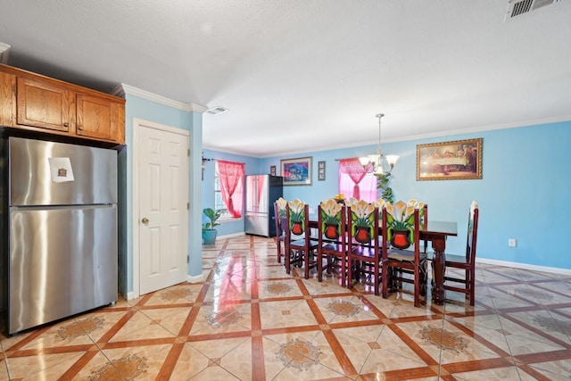 dining room with an inviting chandelier, light tile patterned floors, and crown molding