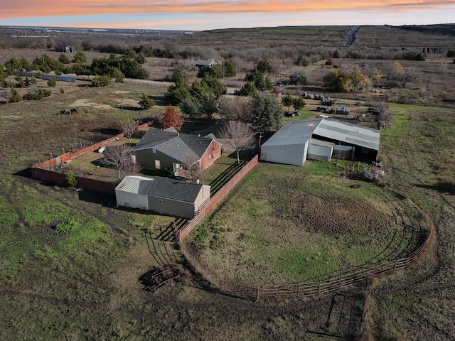 aerial view at dusk featuring a rural view