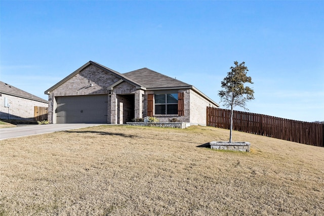 view of front of home featuring a front yard and a garage