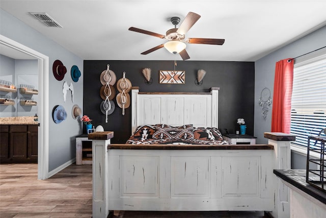 bedroom with ceiling fan and light hardwood / wood-style flooring