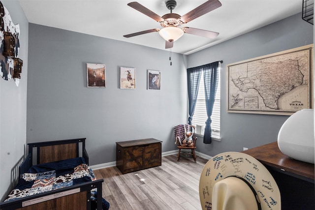 bedroom with ceiling fan and light hardwood / wood-style floors