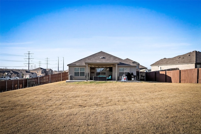 back of house with a lawn