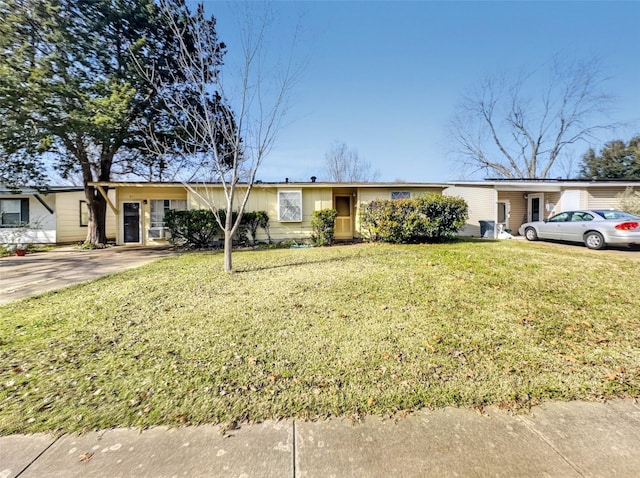 single story home featuring a front lawn