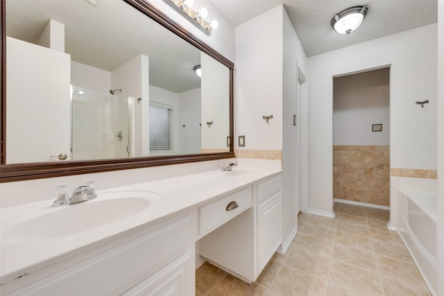 bathroom featuring a bathtub, vanity, and tile patterned flooring