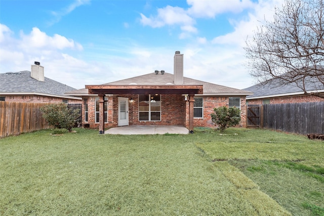 rear view of property with a patio area and a lawn