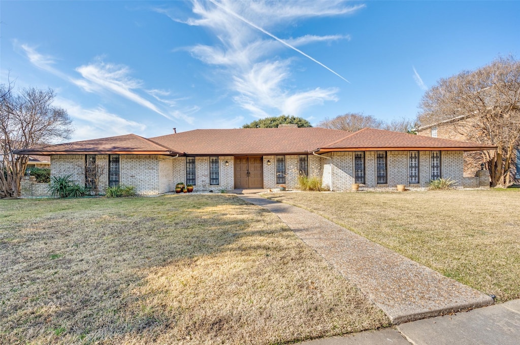 ranch-style house with a front lawn