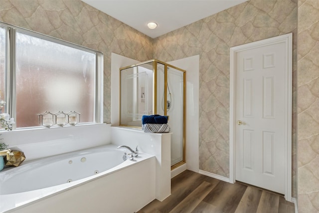 bathroom with wood-type flooring and shower with separate bathtub