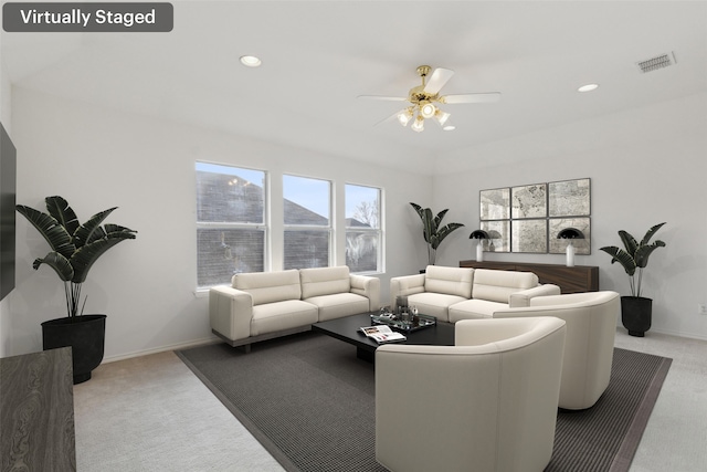 living room featuring light colored carpet and ceiling fan