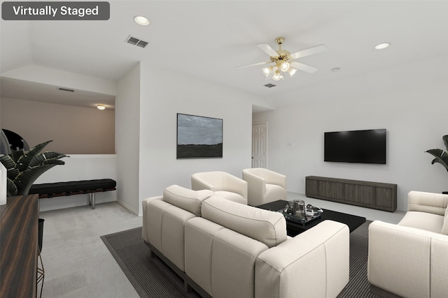 carpeted living room featuring ceiling fan