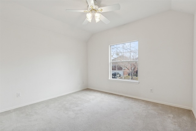 carpeted spare room with lofted ceiling and ceiling fan