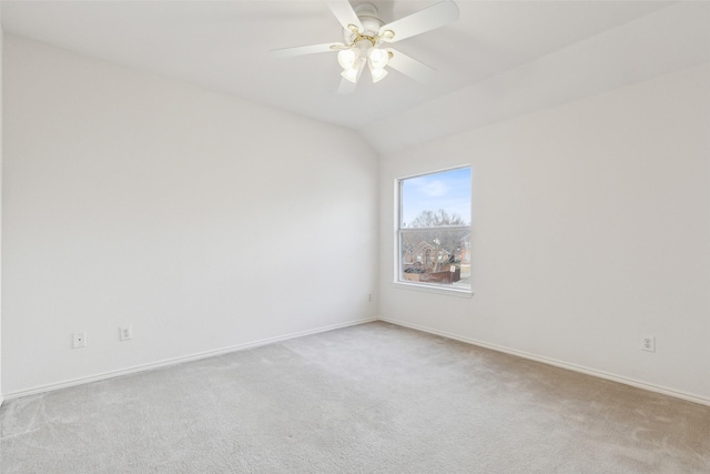 carpeted spare room featuring lofted ceiling and ceiling fan