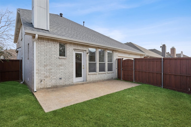 rear view of house featuring a patio area and a lawn