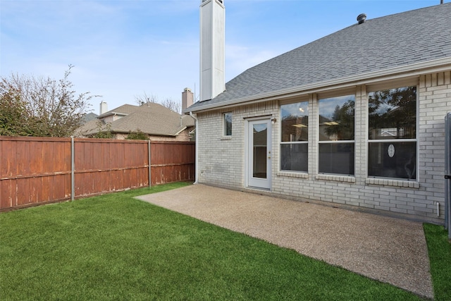 rear view of house with a yard and a patio area