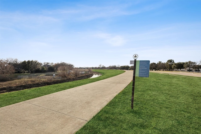 view of property's community with a lawn