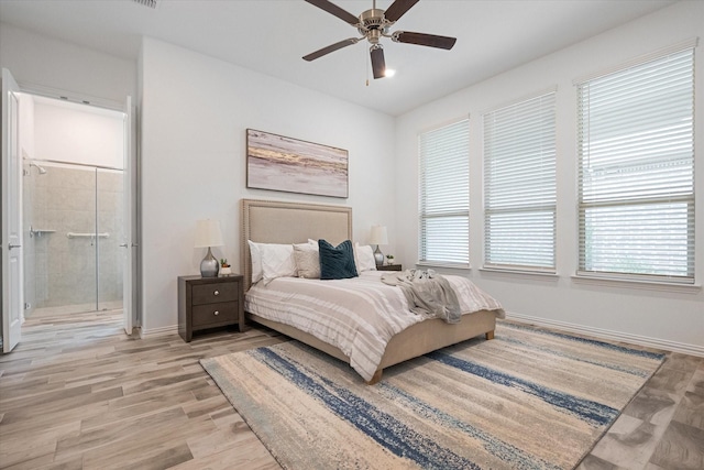 bedroom with ceiling fan, connected bathroom, and light wood-type flooring