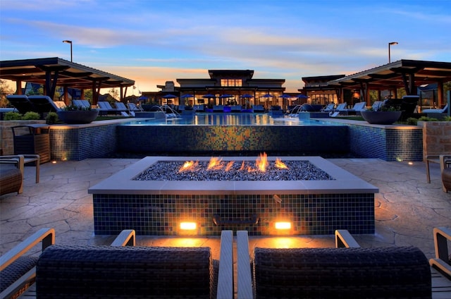 patio terrace at dusk featuring a gazebo and an outdoor fire pit