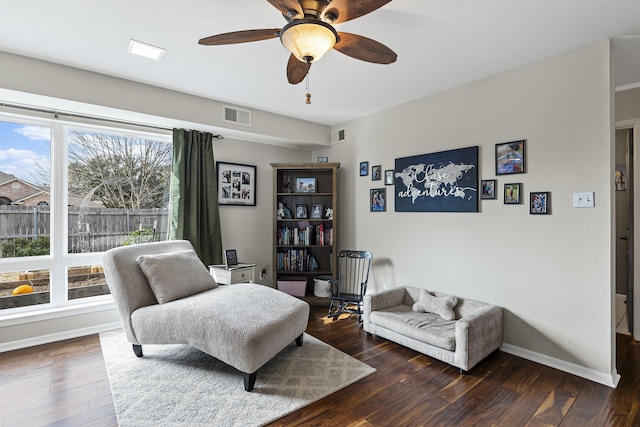 sitting room featuring a ceiling fan, hardwood / wood-style flooring, visible vents, and baseboards