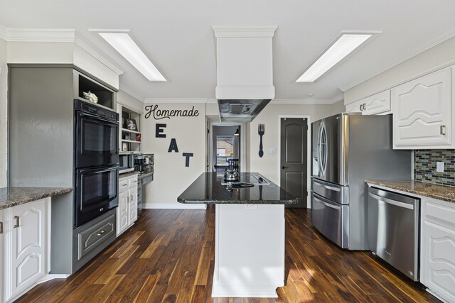 kitchen with dark stone counters, black appliances, crown molding, and white cabinets