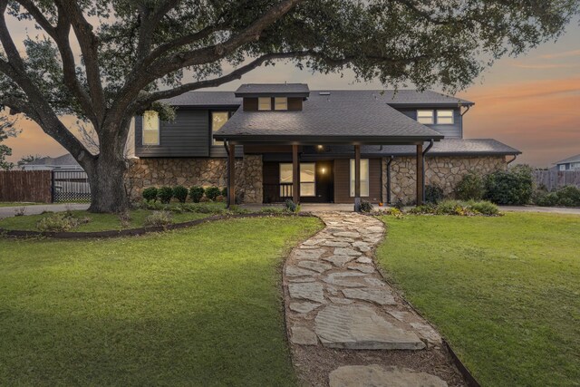 doorway to property featuring a lawn