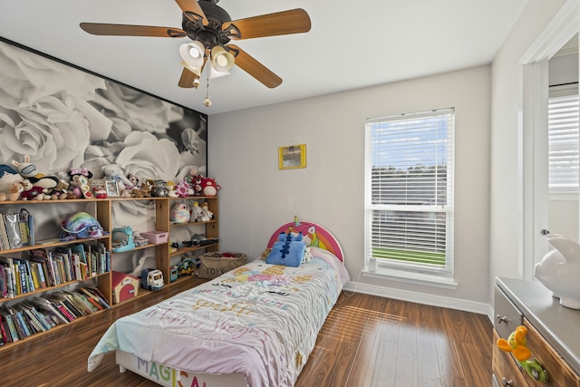 bedroom with a ceiling fan, baseboards, and wood finished floors