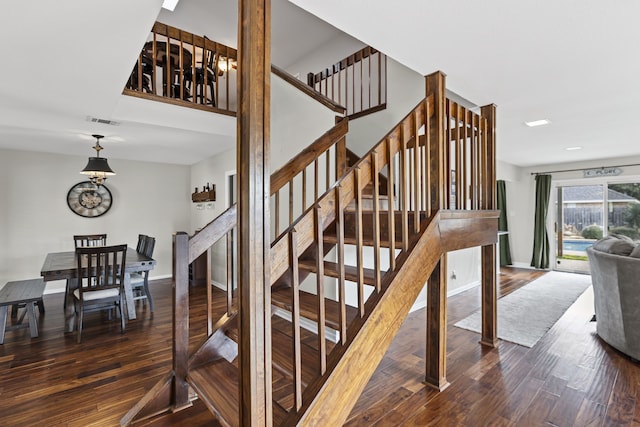 stairway with hardwood / wood-style floors