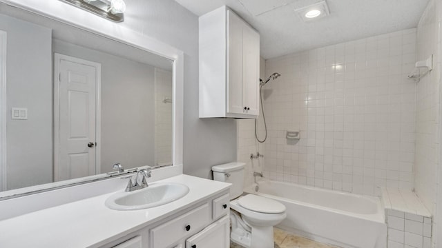 full bathroom with toilet, tile patterned flooring, tiled shower / bath combo, and vanity