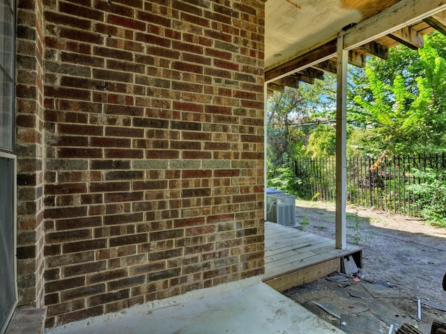 view of patio / terrace with central AC unit and a wooden deck