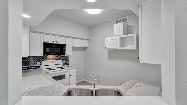 kitchen featuring sink, backsplash, white range with electric stovetop, and white cabinetry