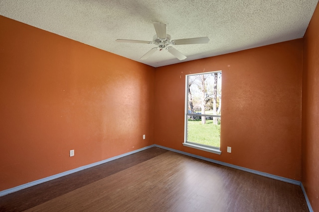 spare room with ceiling fan, a textured ceiling, and hardwood / wood-style flooring