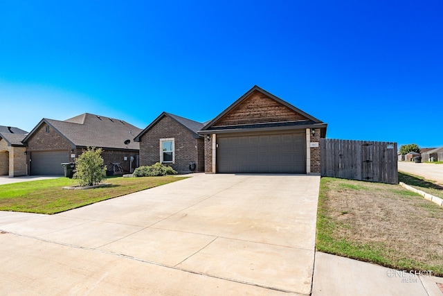 view of front of property featuring a front yard and a garage