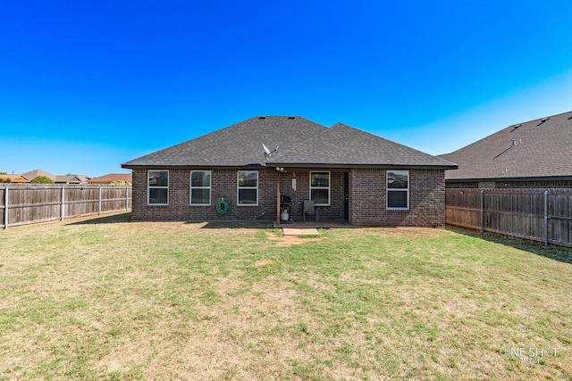 back of house featuring a lawn and a patio