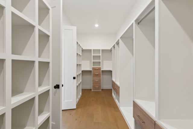 spacious closet with light hardwood / wood-style floors