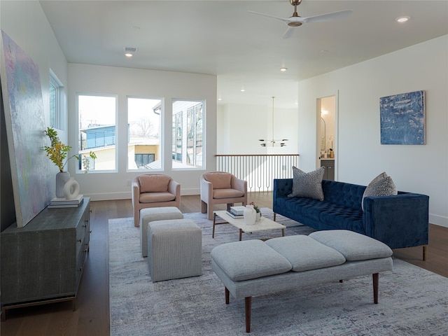 living room featuring wood-type flooring and ceiling fan