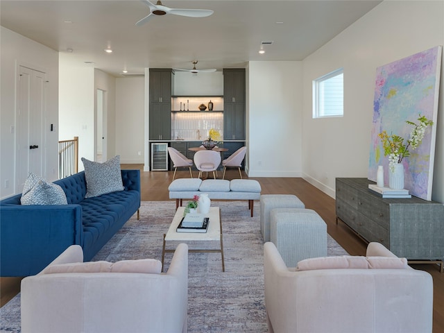 living room featuring wine cooler, ceiling fan, and wood-type flooring