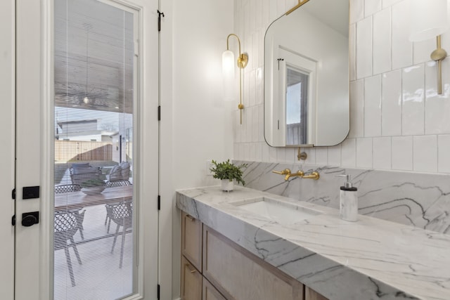 bathroom with tasteful backsplash and vanity