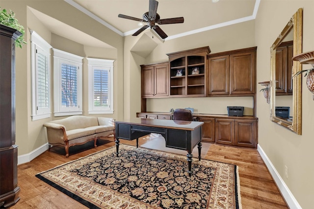 home office with ceiling fan, ornamental molding, and light wood-type flooring