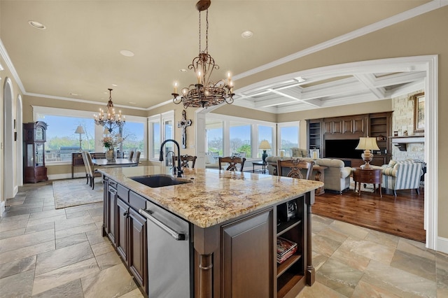 kitchen featuring coffered ceiling, a kitchen island with sink, sink, stainless steel dishwasher, and beamed ceiling