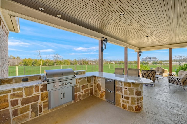 view of patio featuring exterior kitchen and grilling area