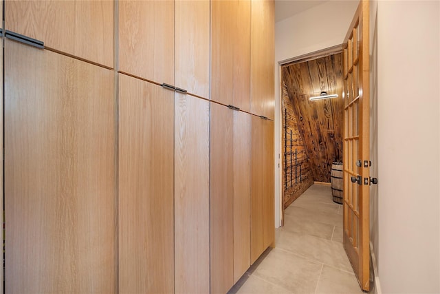 hall featuring light tile patterned floors