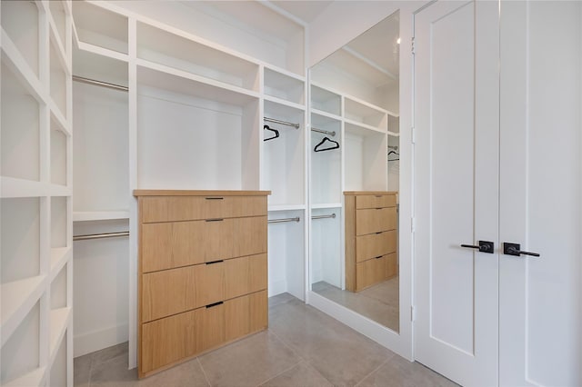 spacious closet with light tile patterned flooring