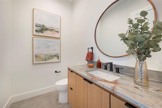 bathroom featuring tile patterned floors, vanity, and toilet