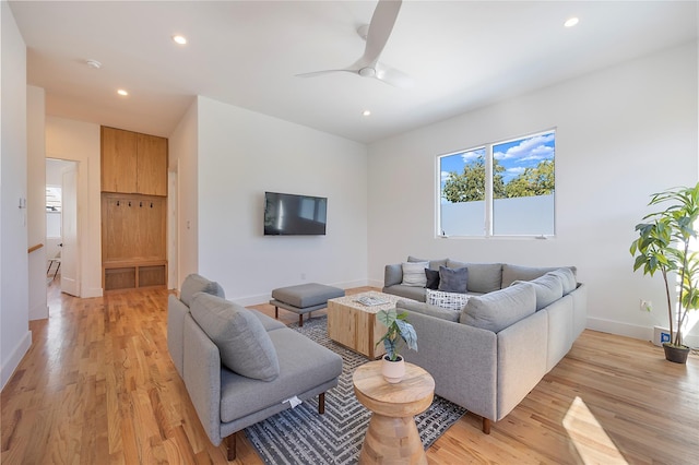 living room with ceiling fan and light wood-type flooring