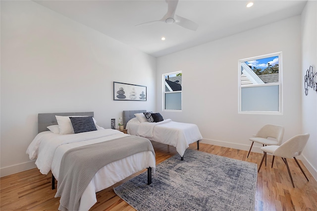 bedroom with ceiling fan and light wood-type flooring