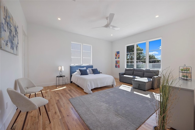 bedroom with ceiling fan and light wood-type flooring