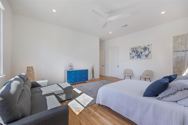 bedroom with ceiling fan and light hardwood / wood-style floors